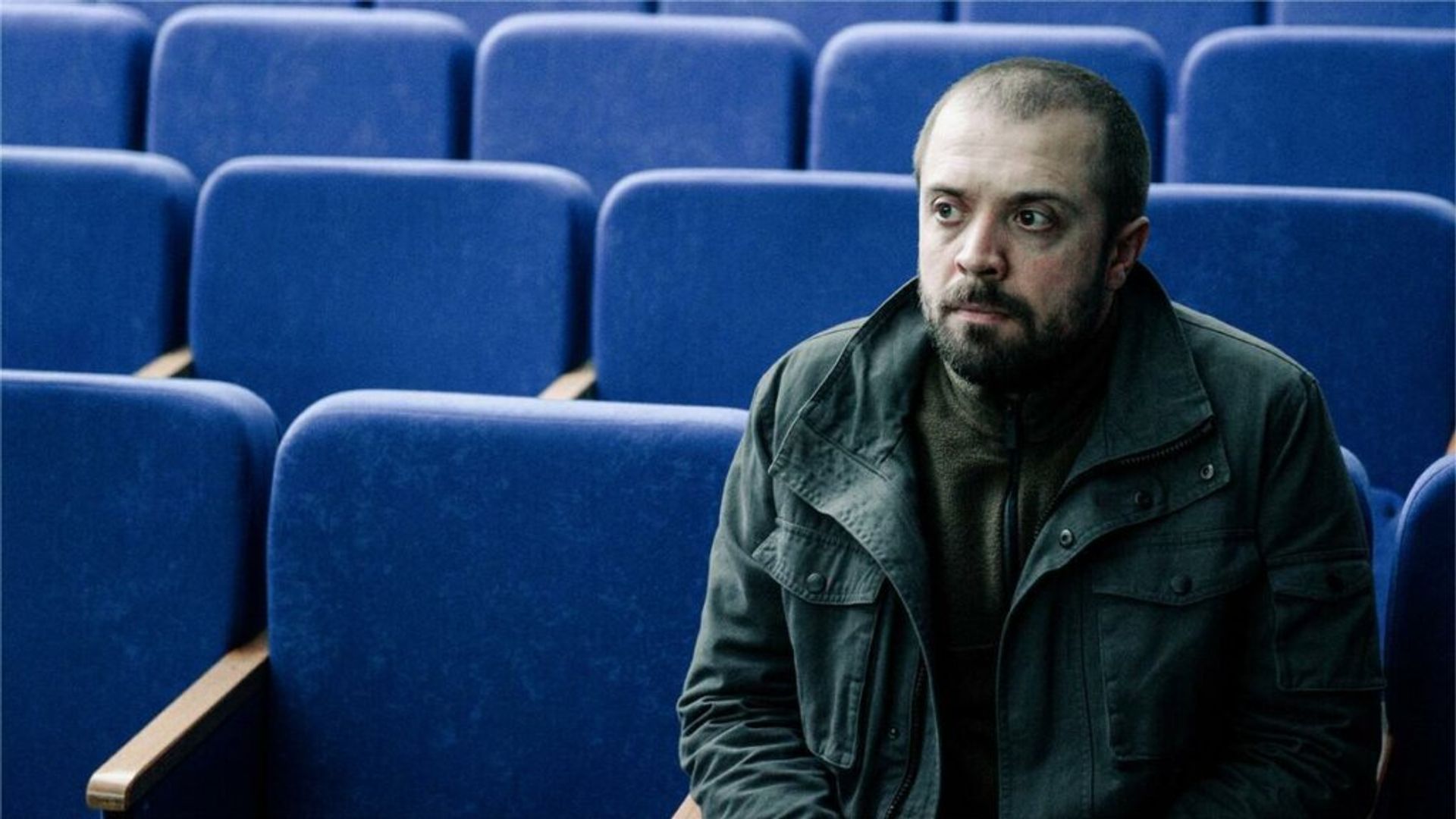 Александр Ильин сидит на сиденье в кинотеатре