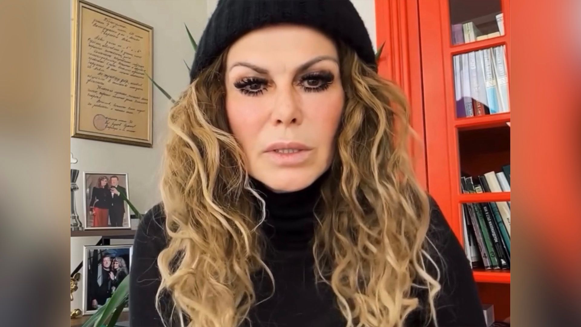 Регина Мянник в чёрной шапке и с длинными вьющимися волосами