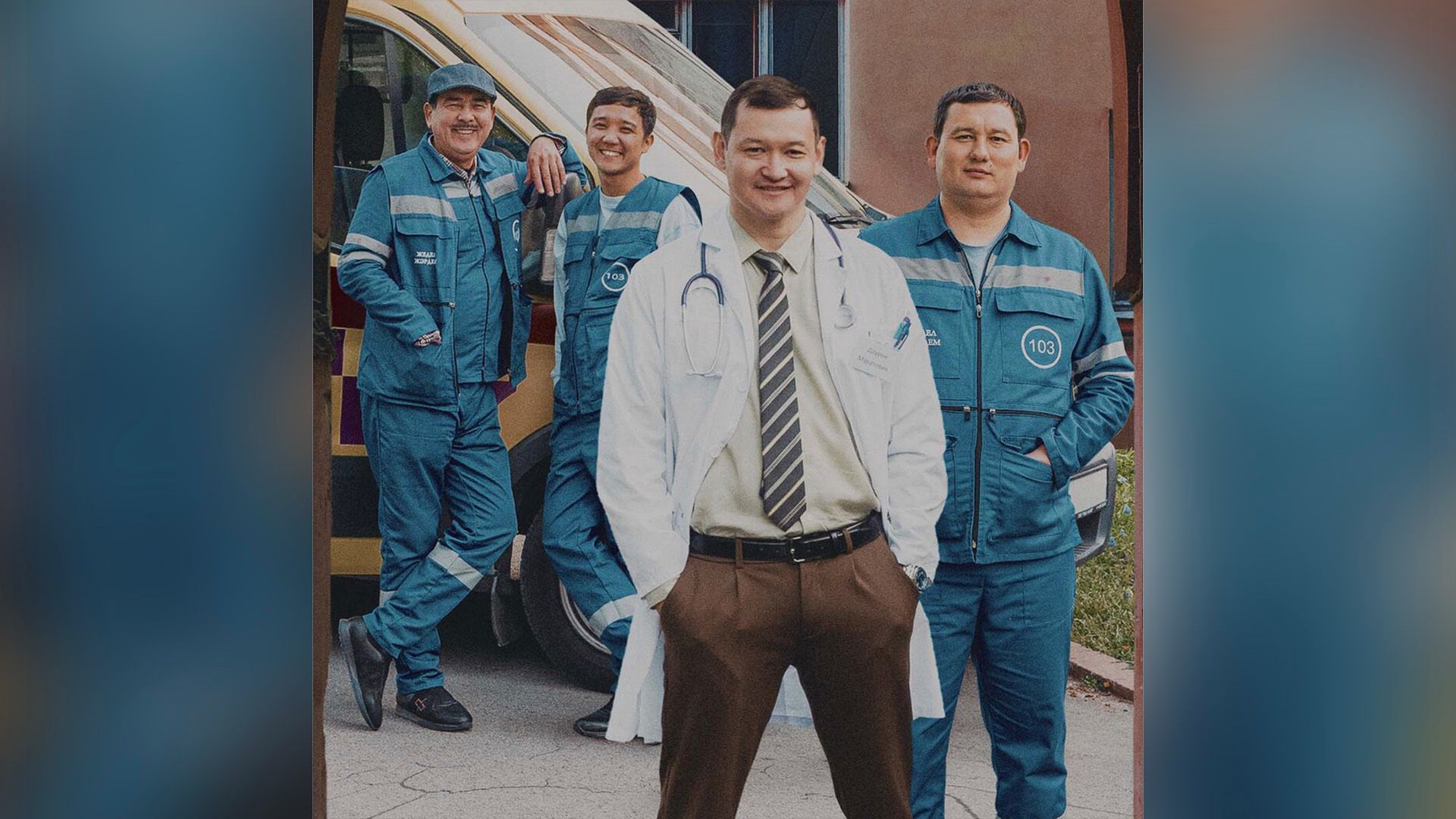 Ренат Мухамбаев в белом халате стоит рядом с тремя мужчинами в форме фельдшеров скорой помощи