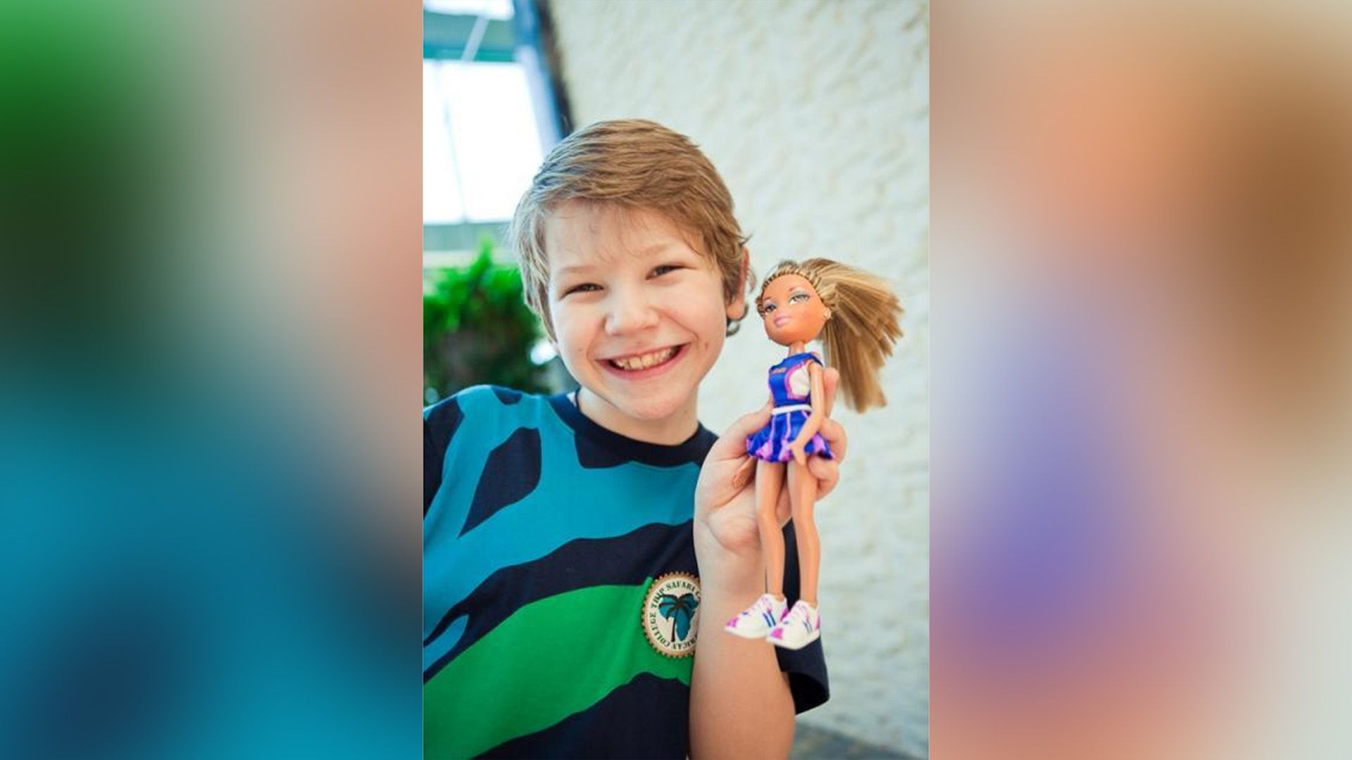 Антон Шаврин в детстве с широкой улыбкой держит в руке куклу Bratz