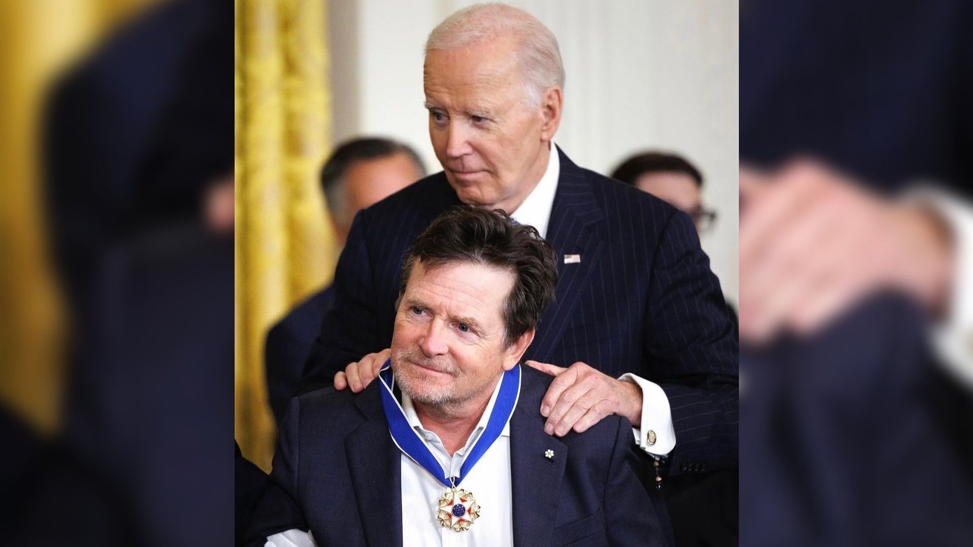 Майкл Джей Фокс с наградой на груди, позади него стоит Джо Байден