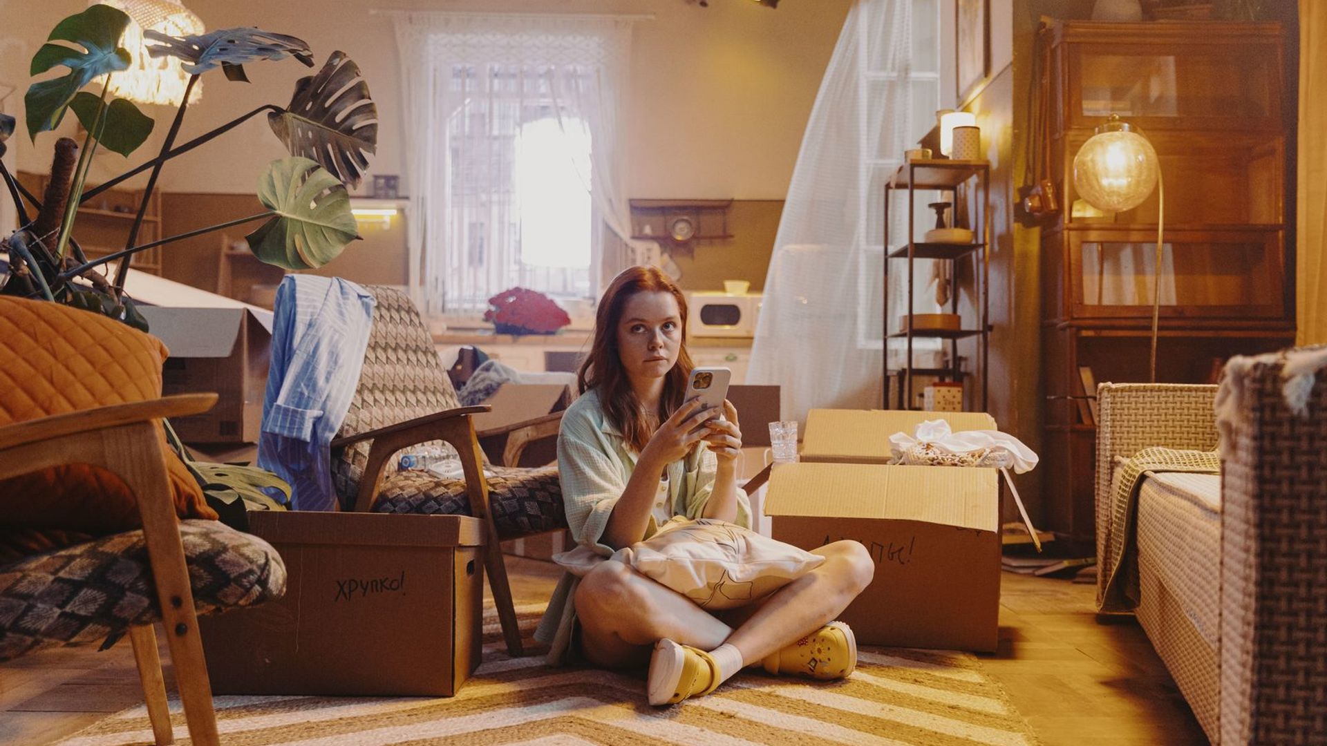 Мила Ершова сидит на полу в центре петербургской квартиры